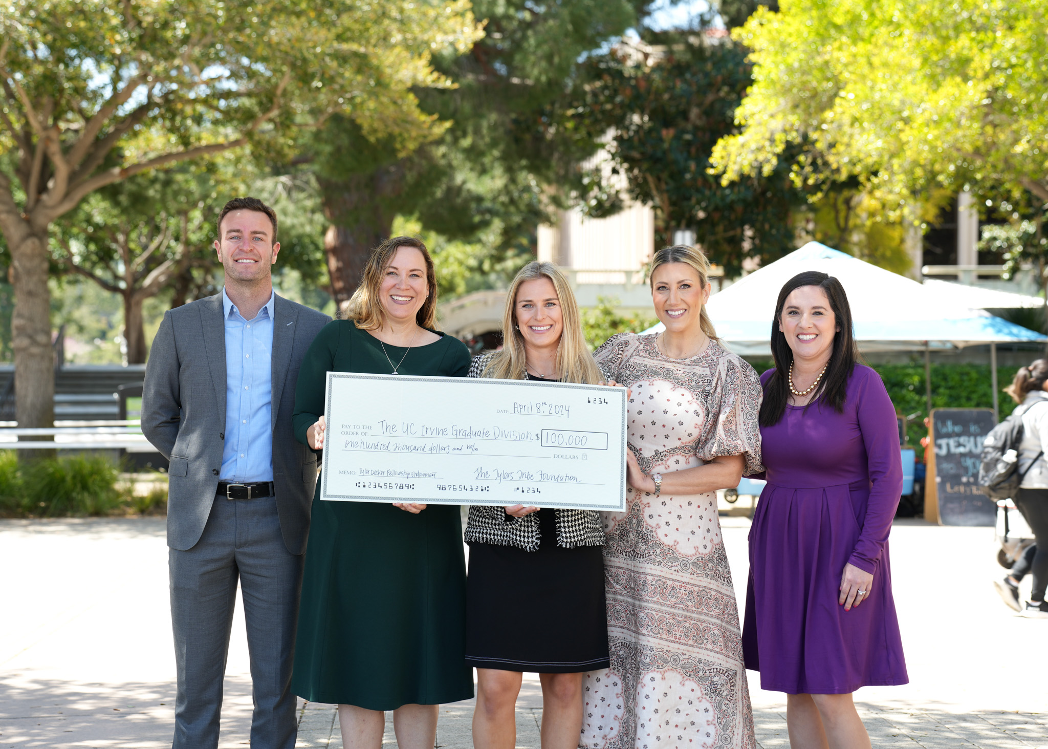 Members of the Tyler's Tribe Foundation and UCI Graduate Division posing with an endowment check to help fund ALS research at UCI.