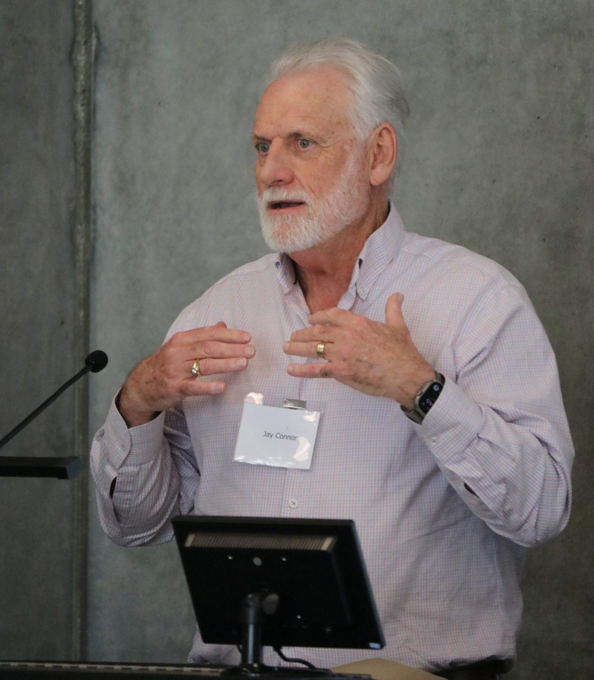 Jay Connor speaking into a microphone