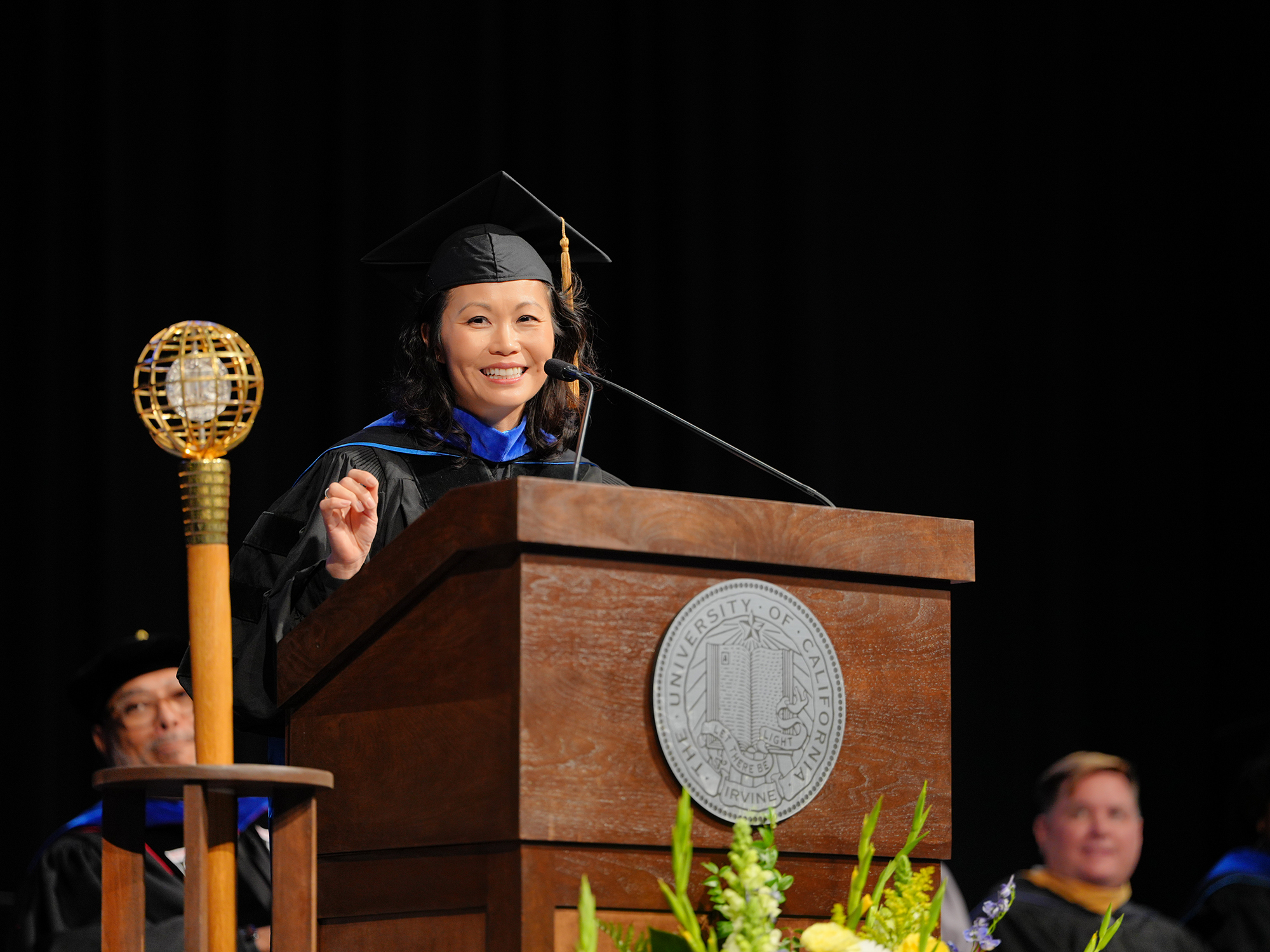 Jenny Woo speaking at podium
