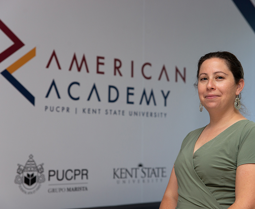 Johanna Solomon posing in front of a sign that says "American Academy"